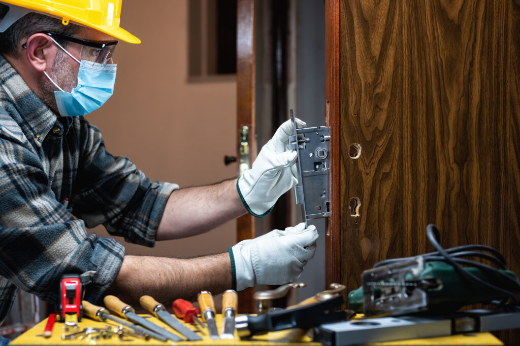 Technician repairing a traditional door lock, ensuring reliable door security