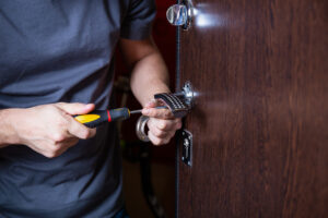 Professional locksmith performing detailed repair for secure door access